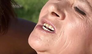 Brunette teenage sharp practice close to his old mother outdoors
